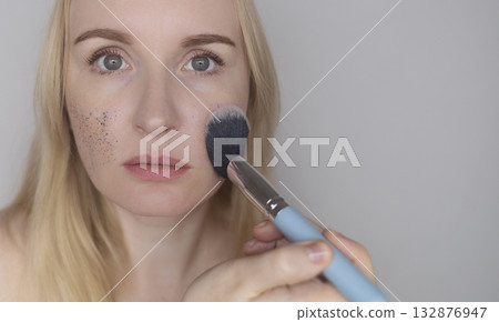 Microplastics in cosmetics. A woman applied a care cream to her skin, now it is covered with plastic particles and microbeads. Cosmetics toxicity concept Microplastics in cosmetics. A woman applied a care cream to her skin, now it is covered with plastic particles and microbeads. Cosmetics toxicity concept 132876947