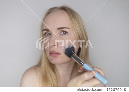 Microplastics in cosmetics. A woman applied a care cream to her skin, now it is covered with plastic particles and microbeads. Cosmetics toxicity concept 132876948