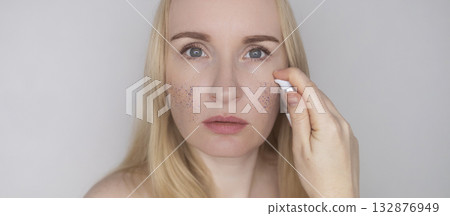 Microplastics in cosmetics. A woman applied a care cream to her skin, now it is covered with plastic particles and microbeads. Cosmetics toxicity concept 132876949
