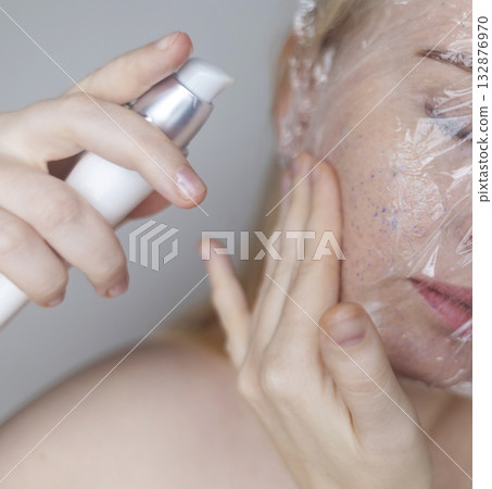 Microplastics in cosmetics. A woman applied a care cream to her skin, now it is covered with plastic particles and microbeads. Cosmetics toxicity concept Microplastics in cosmetics. A woman applied a care cream to her skin, now it is covered with plastic particles and microbeads. Cosmetics toxicity concept 132876970