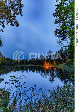 Autumn leaves of the deep forest reflected in a quiet pond Autumn leaves of the deep forest reflected in a quiet pond 132877200