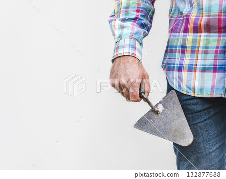 Handsome man, work clothes and masonry trowel Handsome man, work clothes and masonry trowel 132877688