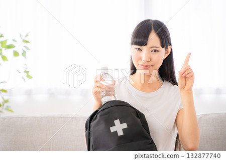 Young woman with disaster prevention backpack 132877740