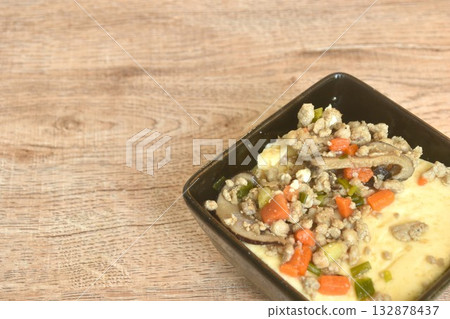 steamed egg with water topping slice black mushroom and chop pork topping carrot in cup on table  132878437
