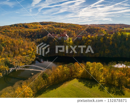 Beautiful autumn landscape with a castle from above from a drone. Beautiful Gothic castle Veveri. The city of Brno at the Brno dam. South Moravia  Czech Republic  Central Europe. 132878871