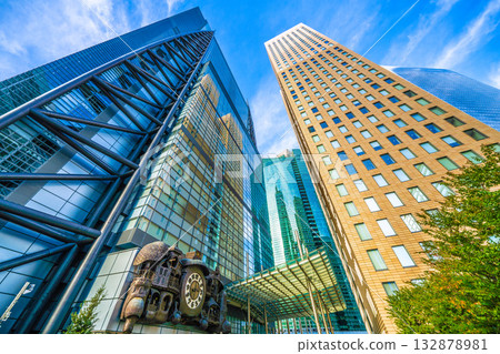 Tokyo cityscape in Japan, with a view of the Shiodome symbol, the mechanical clock "NTV Big Clock," and the Yurikamome train (in the background) running. 132878981