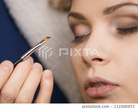 Woman getting eyes make up done by artist Woman getting eyes make up done by artist 132880855