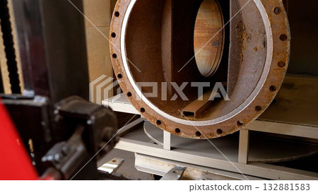 Rusted industrial pipe flange in workshop 132881583