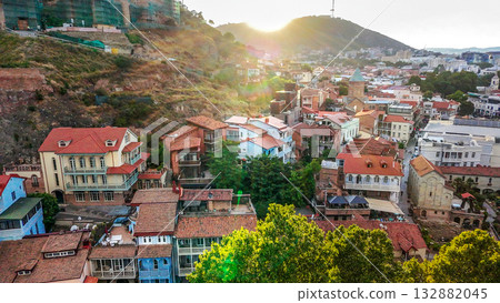 vIEW ON OLD TOWN OF tBILISI IN SUNSET. cABLE CAR IN AIR AND tv TOWER IN DISTANCE 132882045