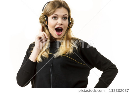 Suprised woman wearing headphones 132882087