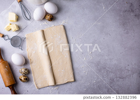 Raw puff pastry dough with baking ingredient 132882396