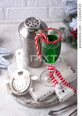 Christmas green cocktail punch with candy cane Christmas green cocktail punch with candy cane 132882416