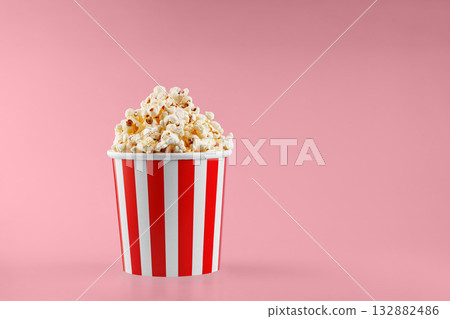 Classic red striped popcorn cardboard cup on Red background Classic red striped popcorn cardboard cup on Red background 132882486