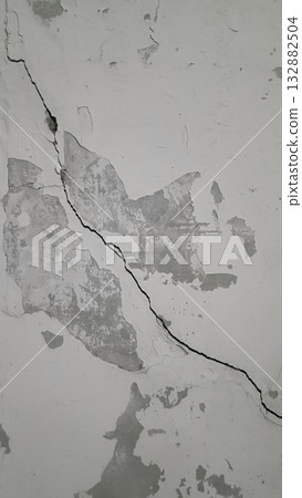 Cracked wall texture damaged plaster gray concrete surface rough peeling paint urban decay vertical fissure gritty mood Cracked wall texture damaged plaster gray concrete surface rough peeling paint urban decay vertical fissure gritty mood 132882504