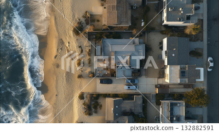Aerial beach house coastal house ocean shore sandy beach drone view waterfront property sunset light residential street 132882591