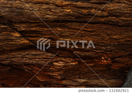 Stacked rocky strata with rich brown and ochre colors 132882921