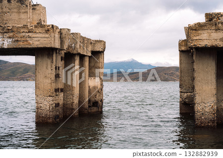 Gap between ruined concrete piers on water 132882939