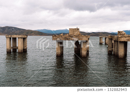 Abandoned concrete pillars standing in reservoir panorama 132882943
