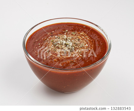 Glass bowl of tomato cream soup on white background 132883543