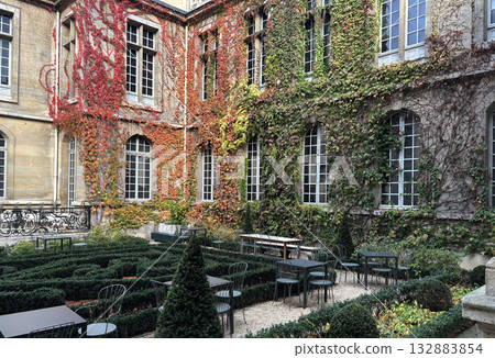 Autumnal courtyard of the Carnavalet Museum, which specializes in the history of Paris, located in the 3rd arrondissement of Paris, the French capital. 132883854