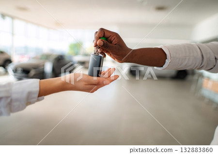 Person handing car keys during new car purchase 132883860