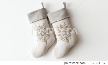 Minimalist Scandinavian linen Christmas stockings in soft beige and grey tones, isolated on white background. Minimalist Scandinavian linen Christmas stockings in soft beige and grey tones, isolated on white background. 132884137