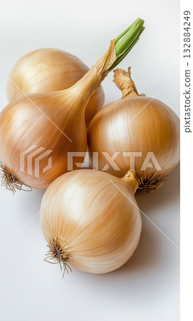 Raw onions with natural golden skin styled on white, ideal for rustic kitchen and farm-to-table projects. Raw onions with natural golden skin styled on white, ideal for rustic kitchen and farm-to-table projects. 132884249