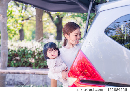 Mother riding in a car with a baby 132884336