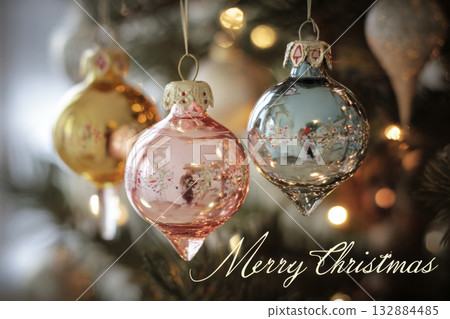 Colorful retro ornaments from the 50s and 60s dangle from a Christmas tree, surrounded by twinkling lights, capturing the joyful spirit of the holiday season 132884485