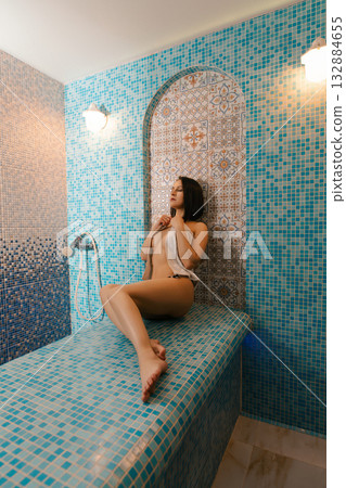 Woman enjoying a relaxing moment in a tranquil spa environment Woman enjoying a relaxing moment in a tranquil spa environment 132884655