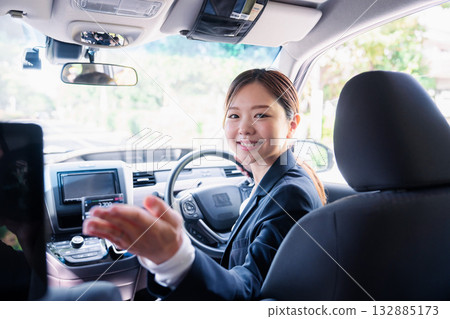 一位年輕的女計程車司機正在講解如何付款。 一位年輕的女計程車司機正在講解如何付款。 132885173