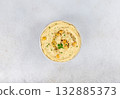 Creamy lupini bean hummus with herbs and olive oil on white background. Healthy vegan dip. Top view. 132885373