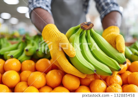 Green Bananas and Fresh Oranges in Market Hands 132885458