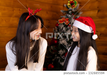 Two friends are sharing a joyful moment during the Christmas season 132885594