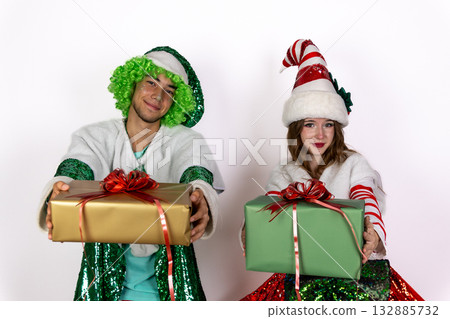 people dressed as elves holding Christmas presents, smiling joyfully 132885732