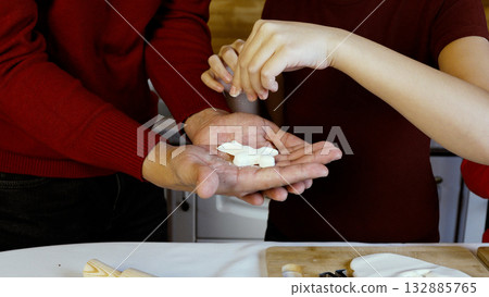 Mother and daughter are making Christmas cookies together 132885765