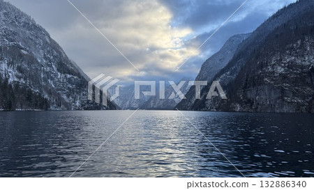 Serene winter landscape at Koenigsee with mountains reflecting in calm waters 132886340