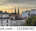 The twin spires of the Church of Saint John the Baptist in Béville, in the 19th arrondissement of Paris, in the early morning. The church is in the Neo-Gothic style. 132886367