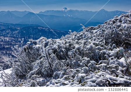 Mount Nikko Shirane and frost-covered trees seen from Mount Koshibutsu during the snowy season 132886441