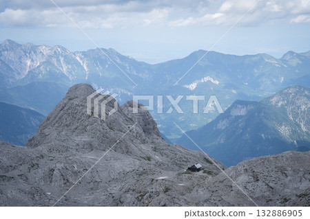 Landscape with solitary mountain hut located on a rocky alpine terrain, Triglav Nat Park, Slovenia Landscape with solitary mountain hut located on a rocky alpine terrain, Triglav Nat Park, Slovenia 132886905
