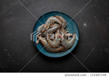 Fresh raw shrimps prawns plate dark background seafood uncooked healthy Fresh raw shrimps prawns plate dark background seafood uncooked healthy 132887146