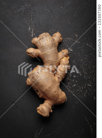 Fresh raw single ginger root black dark background healthy alternative medicine immunity Fresh raw single ginger root black dark background healthy alternative medicine immunity 132887160