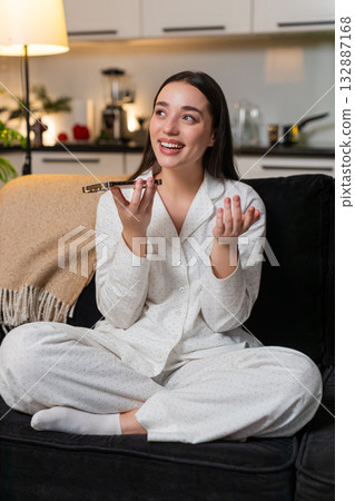 Young woman talks on smartphone speaker cheerful chat laughs shares news warm voice asks questions Young woman talks on smartphone speaker cheerful chat laughs shares news warm voice asks questions 132887168