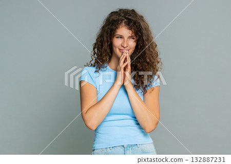 Young woman slyly rubbing hands scheming cunning sneaky mischievous playful secretive gesture mood Young woman slyly rubbing hands scheming cunning sneaky mischievous playful secretive gesture mood 132887231