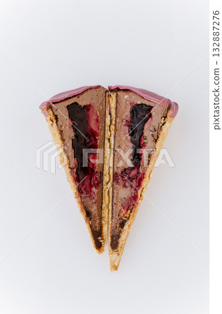 Sliced chocolate berry ice cream with waffle crust and berry sauce filling, macro close-up 132887276
