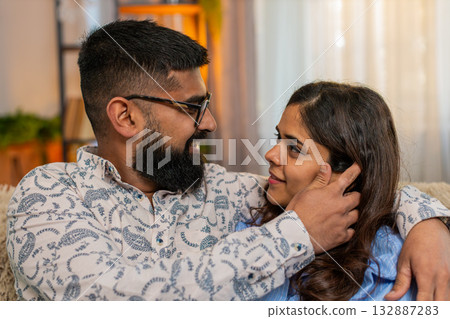 Indian family couple man woman touching face and looking at each other with love and tenderness Indian family couple man woman touching face and looking at each other with love and tenderness 132887283