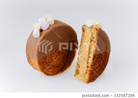 Chocolate-covered croissant roll with mini marshmallows on white background 132887286