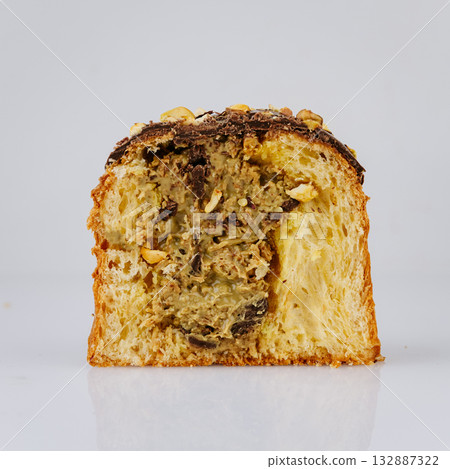 Sliced Christmas panettone with rich nut cream filling, isolated on white Sliced Christmas panettone with rich nut cream filling, isolated on white 132887322