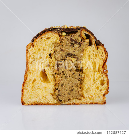 Sliced Christmas panettone with rich nut cream filling, isolated on white Sliced Christmas panettone with rich nut cream filling, isolated on white 132887327