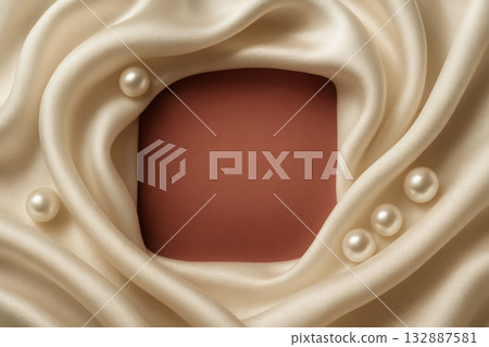 Elegant fabric with pearls surrounding a blank square for beauty product display on soft cream 132887581